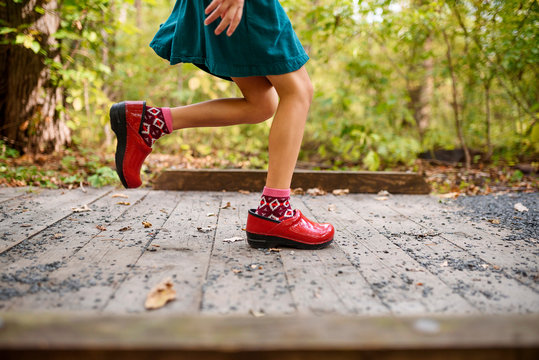 Girl running across a small footbridge, United States