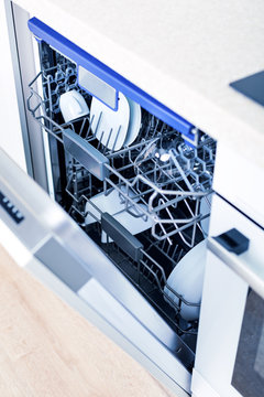 Home appliance dishwashing machine in kitchen interior, no people