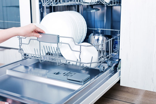 Home appliance dishwashing machine in kitchen interior, no people