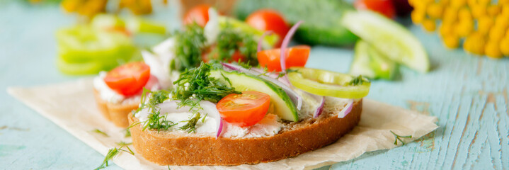 Sandwich with herb pesto and edible nasturtium flowers