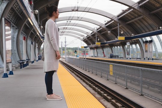 Woman standing on platform at railway station