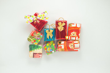 Closeup pile of  gift boxes wrapped by colorful paper for Christmas festival with isolated background