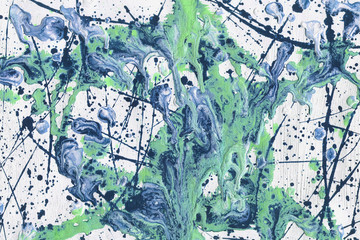 Colorful wet abstract paint leaks and splashes texture on white watercolor paper background. Natural organic shapes and design.