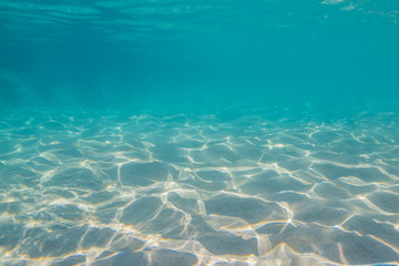 Fototapeta na wymiar Underwater with sand and sunlight