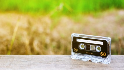 vintage audio cassette tapes on wooden desks in the morning. - vintage backdrop style.