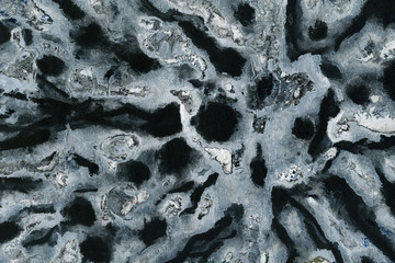 Colorful wet abstract paint leaks and splashes texture on white watercolor paper background. Natural organic shapes and design.