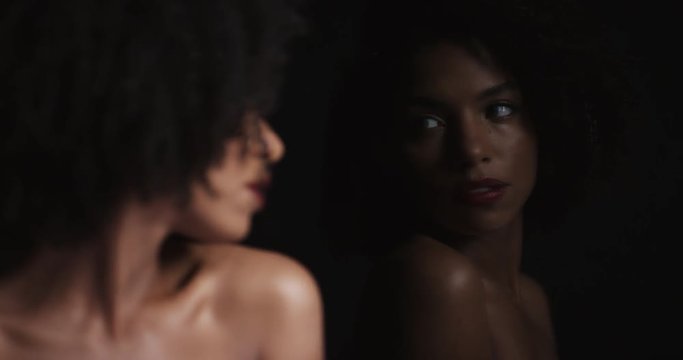 close up portrait beautiful african american woman looking at mirror reflection gorgeous black female enjoying sensual vanity with natural feminine beauty in dark seductive background