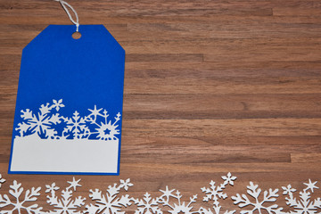 Snowflake tag getting ready to wrap presents