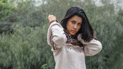 Unemotional Female Youngster Wearing Sweater