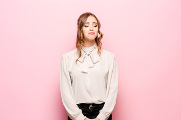 Portrait of displeased upset female frowns face as going to cry, being discontent and unhappy as cant achieve goals, isolated over pink studio background. Dissapointed young woman has troubles