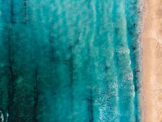 Top view of beautiful beach with turquoise ocean and waves, aerial view