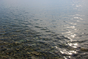 Blue green sea water surface texture ripples summer abstract background afternoon sun reflection