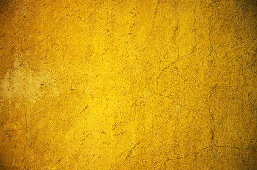 colorful vintage cracked dirty grunge yellow cement wall background