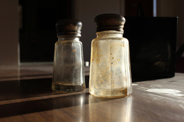 Empty salt and pepper shakers on restaurant table
