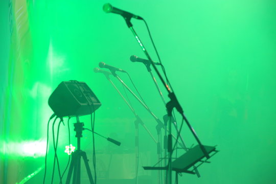 A shot of a stage with several microphones
