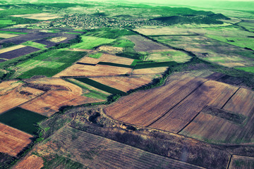 Aerial view of green countryside with small homes