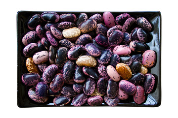 Kidney beans in black rectangular plate isolated on white background
