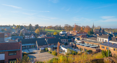 Ancient church in a village on a hill below a blue sky at sunrise at fall