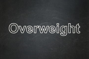 Obraz premium Healthcare concept: text Overweight on Black chalkboard background