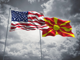 United States of America, USA & Macedonia Flags are waving in the sky with dark clouds