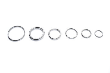 Metal rings of different diameters on a white background. View from above