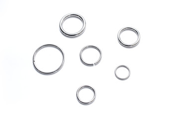 Metal rings of different diameters on a white background. View from above