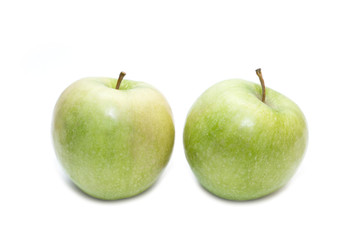 Two juicy green apples isolated on a white background. Side view