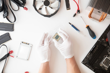Top view of man hands holding cpu, computer parts and accessories, Electronics repair and upgrade...