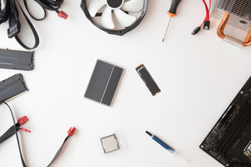 Top view of computer parts and accessories, Electronics repair and upgrade on white desk background, copy space. Motherboard, processor cpu, cooler, radiator, flat lay.