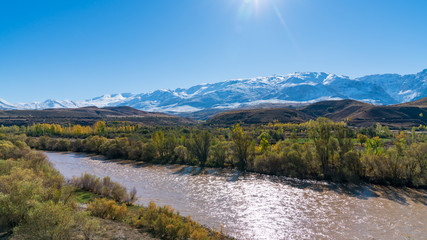 Panoramic view of a valley with snow capped mountains and River Euphrates near Erzincan, Turkey