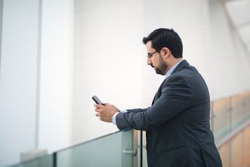 arab business man texting on his phone 