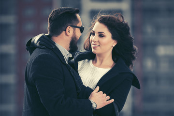 Fototapeta premium Happy young fashion couple walking in city street