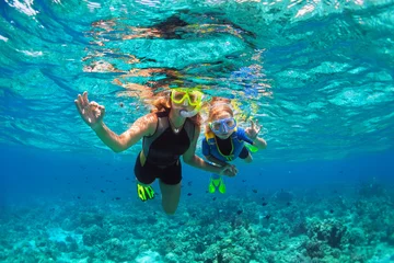 Foto op Aluminium Happy family - mother, kid in snorkeling mask dive underwater with tropical fishes in coral reef sea pool. Show by hands divers sign OK. Travel lifestyle, beach adventure on summer holiday with child. © Tropical studio