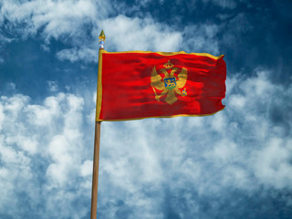 Montenegro flag Silk waving made transparent fabric flag Montenegro with wooden flagpole gold spear on background sunny blue sky white smoke clouds real retro photo Countries of world 3d illustration