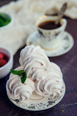 Fresh homemade marshmallow with raspberry and mint on dark background.