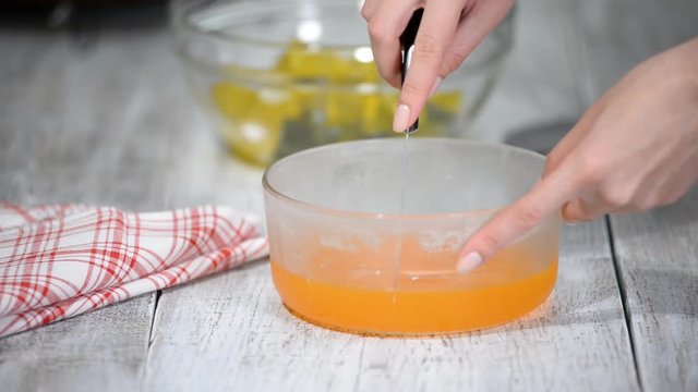 Cutting orange jelly into pieces.