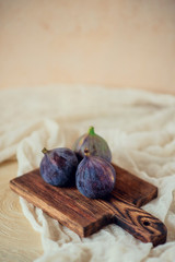 Figs on a light background with textiles and Board in rustic style.
