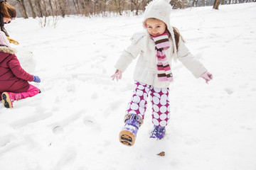 Happy Child Playing On Snow In The Park At Winter Day