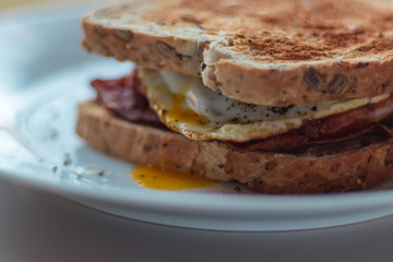 Homemade Breakfast Egg Sandwich with Cheese and bacon on Toast