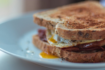 Homemade Breakfast Egg Sandwich with Cheese and bacon on Toast