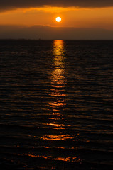 A bright red sunset reflected orange in Lake Constance