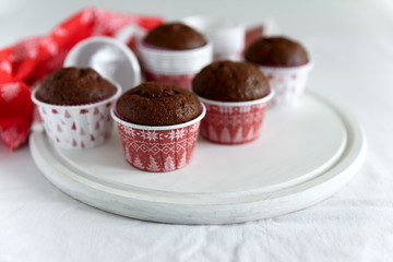 Homemade chocolate muffins (brownies) on white wooden background. Christmas food. Selective focus