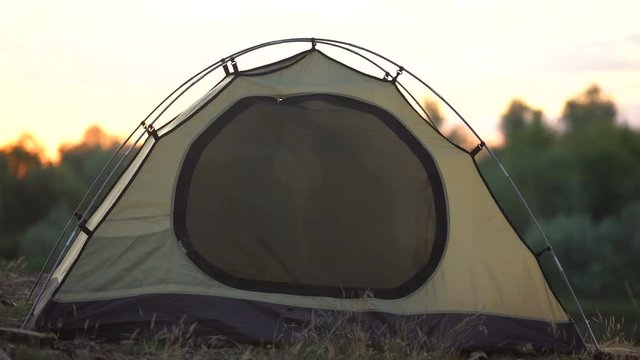 Funny couple zipping dome tent and winking, protection from insects, camping