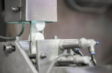 plastic covers on the conveyor, close-up. bottle caps at the factory