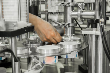 production and bottling of yogurt in plastic cups. equipment at the dairy plant