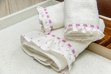 white terry towels with a pink ribbon. soft gentle towels for the bathroom. cream towel set for the...