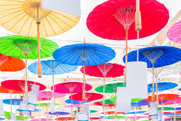 Fototapeta na wymiar Colorful handmade paper umbrella hanging on top