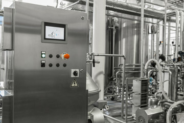 electronic control panel and tank at a milk factory. equipment at the dairy plant