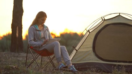 Female using tablet for navigation in woods , 3g internet coverage to rural area