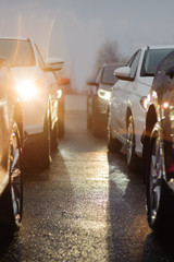 Traffic jam in the rainy night. Row of cars